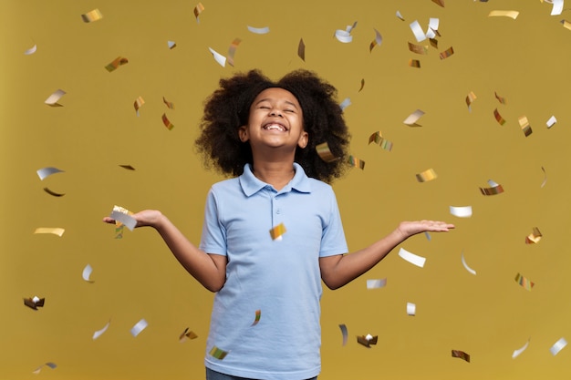 Photo happy girl jumping surrounding by confetti