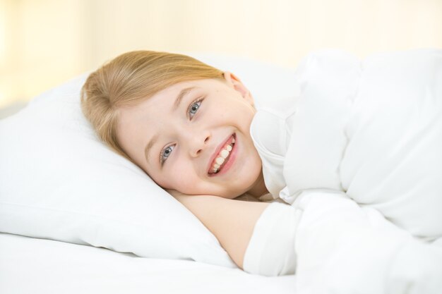 The happy girl lay on the bed