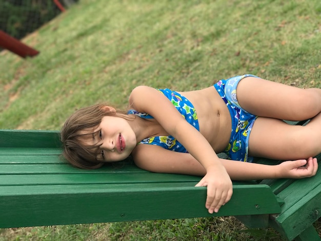 Happy girl lying on grass