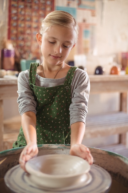 Happy girl making pot