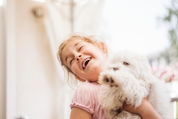 Happy girl playing with dog