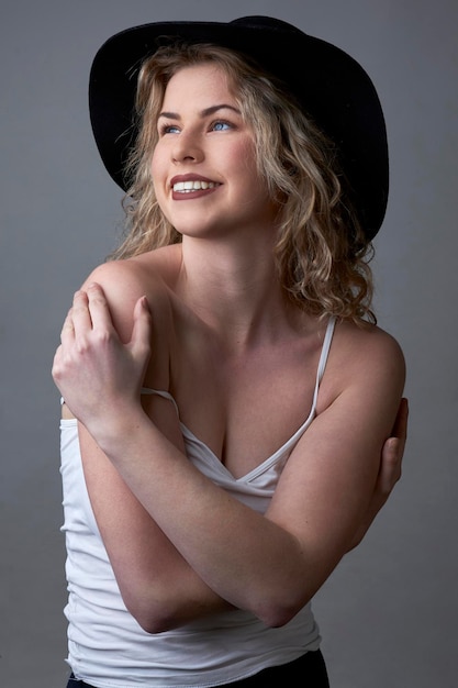 Happy girl posing with hat and white shirt