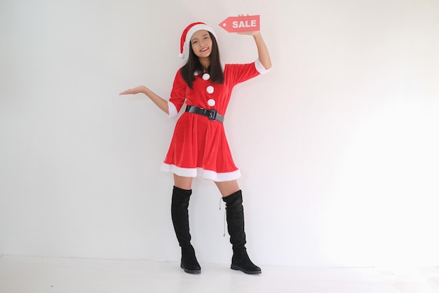 Happy girl in santa claus dress on white background on Christmas party