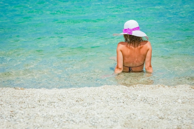 Happy girl at sea in greece on sand nature