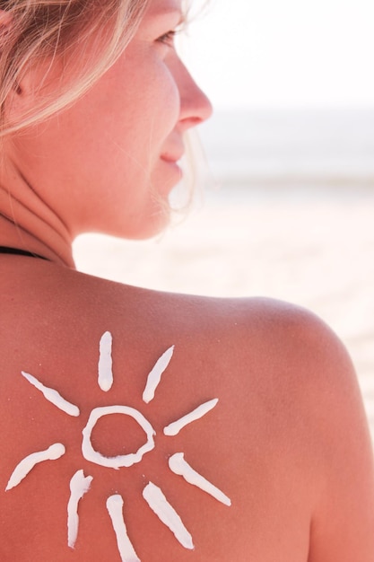 Happy girl on the shoulder of the sun on the beach in the summer on the nature