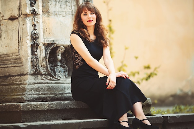 Happy girl sitting on a stairs