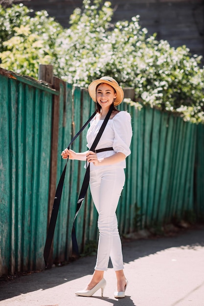 A happy girl in a small hat and with a bouquet of flowers 3600