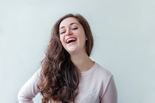 Happy girl smiling. Beauty portrait young happy positive brunette woman isolated on white background. Young european woman portrait, true emotions. Happiness carefree happy people concept.