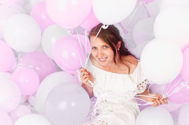 Happy girl smiling, lots of balls, Studio.