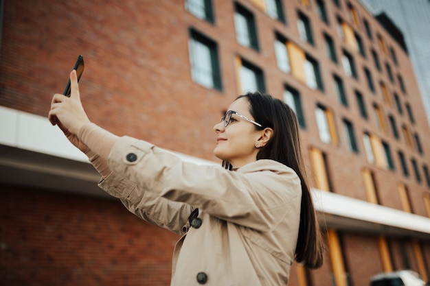 Happy girl taking selfie.