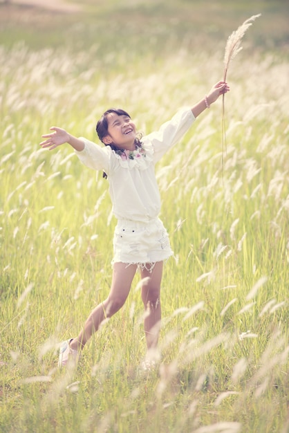 Happy girl walking and playing in the park