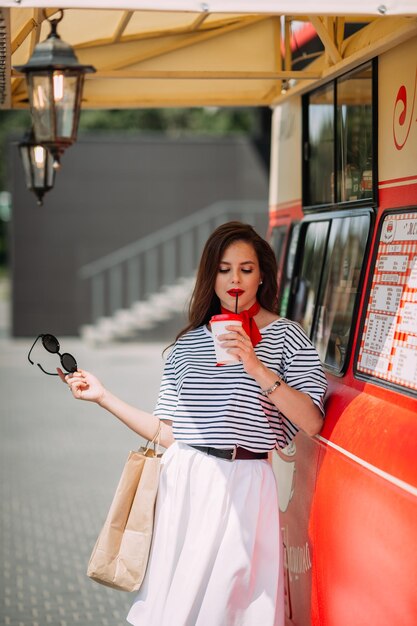 A happy girl walks around the city and shops on a bright day 4203