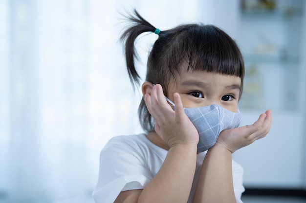 Happy girl  wearing a face mask Girl wearing mask to prevent coronavirus pandemic