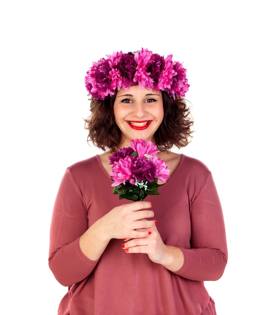 Happy girl with a branch and crown with pink and purple flowers