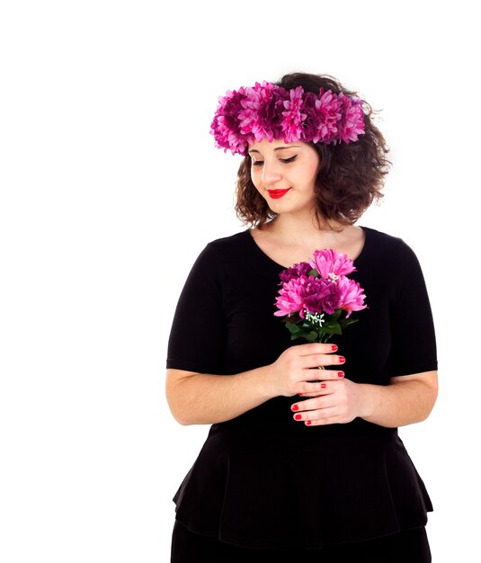 Happy girl with a branch and crown with pink and purple flowers