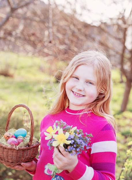 Happy girl with Easter eggs outdoor
