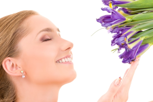 happy girl with flowers over white wall