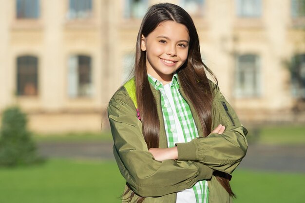 Happy girl with school bag outdoor back to school