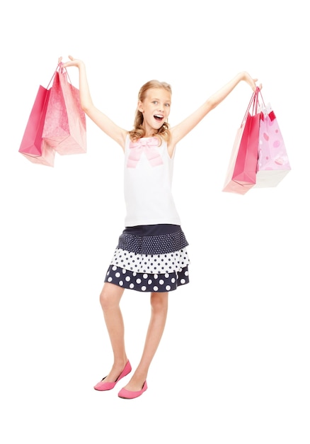 happy girl with shopping bags over white