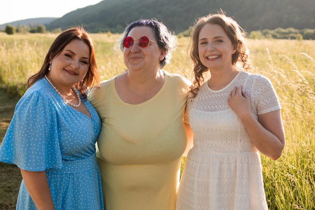 The happy girlfriends are hugging in nature