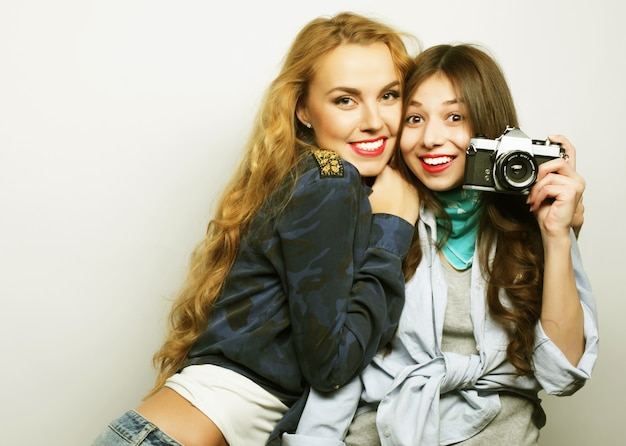 Happy girlfriends taking some pictures with camera