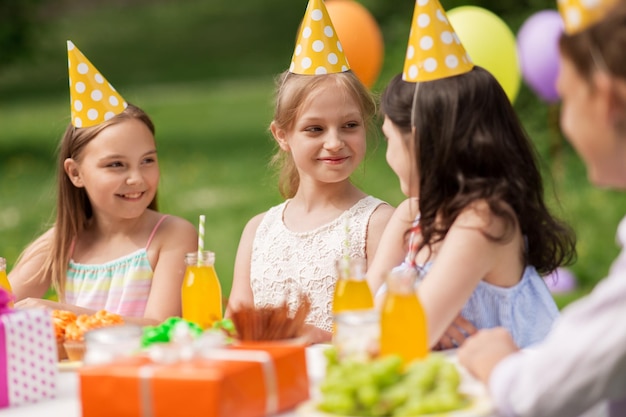 happy girls on birthday party at summer garden