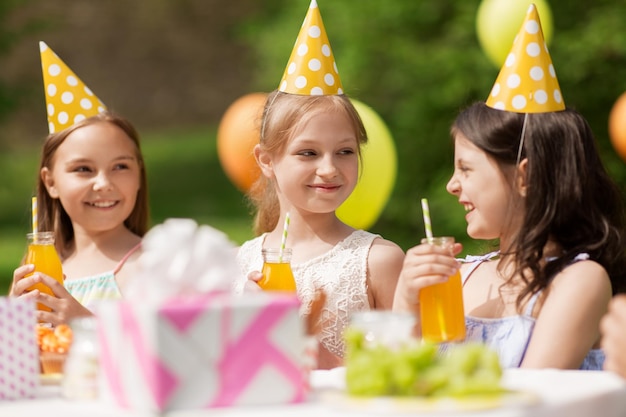 happy girls on birthday party at summer garden