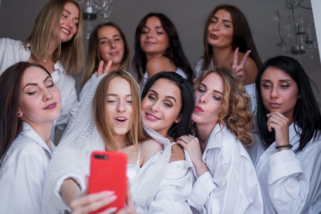 happy girls in white men's shirts that celebrate a bachelorette party