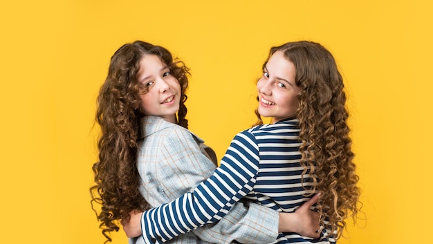 Happy girls with long windy hair healthy and strong hair\
hairdresser beauty salon nice and tidy hairstyle sisters active\
kids with long gorgeous hair extra fresh dry shampoo