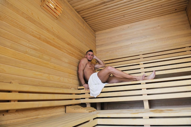 happy good looking and attractive young man with muscular body  relaxing in sauna hot