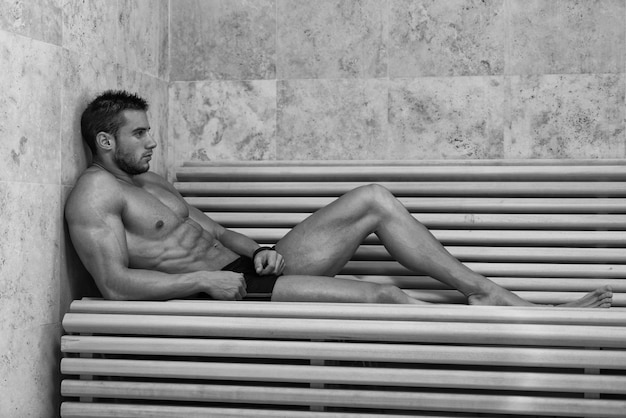 Happy Good Looking And Attractive Young Man With Muscular Body Relaxing In Sauna Hot