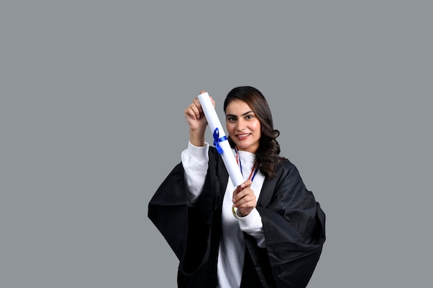 Happy graduate student girl holding a diploma in hand indian pakistani model