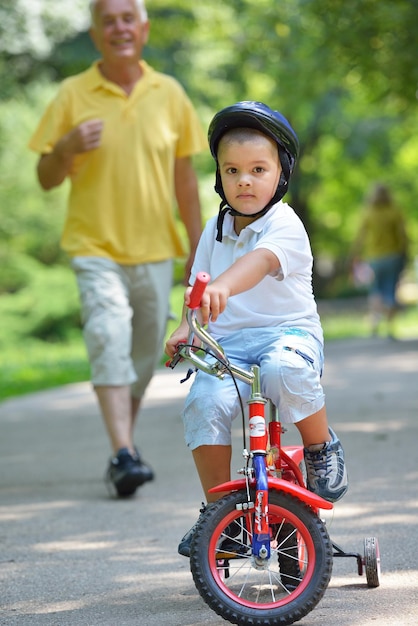 happy grandfather and child have fun and play in park