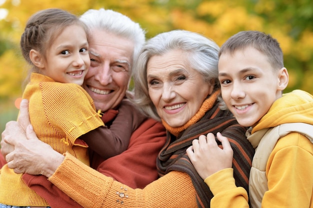 Happy grandfather grandmother and grandchildren in park