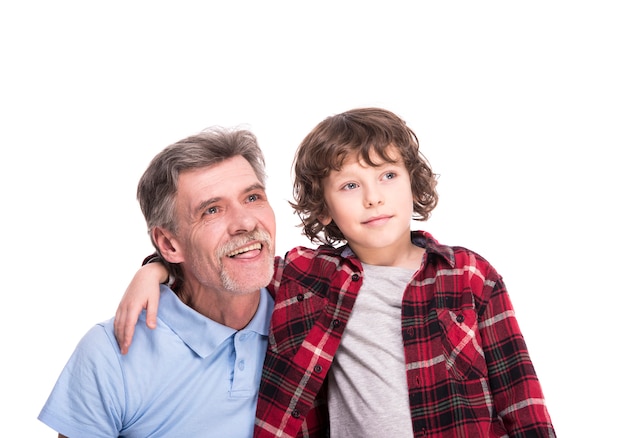 Happy grandfather and his grandson are looking away.