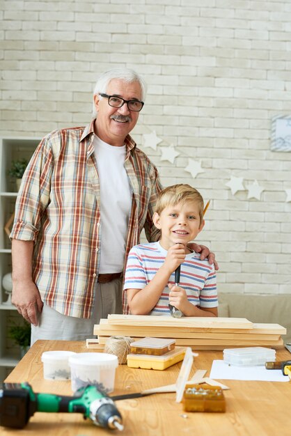 Happy Grandfather Posing with Cute Grandson