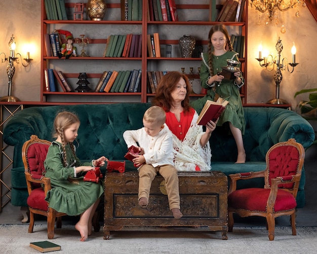 Happy grandma and grandchildren reading book together and having fun at home