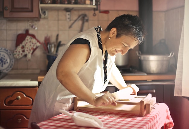 Happy grandma making pasta