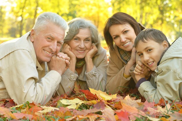 Happy grandmother with boy resting in the autumn park