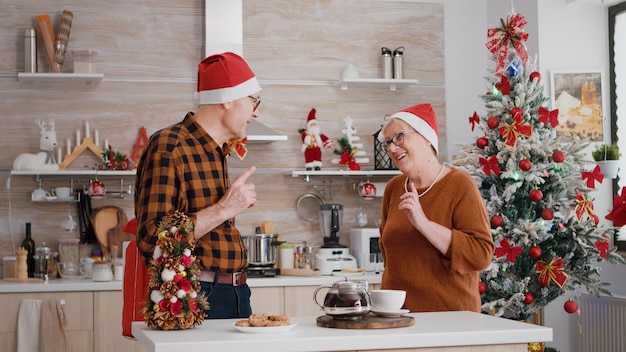 Happy grandparents couple family sharing wrapper gift with ribbon on it