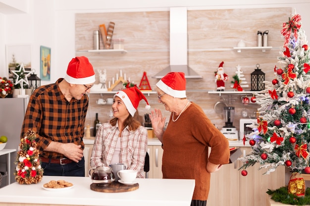 Happy grandparents surprising granddaughter with xmas present gift with ribbon on it