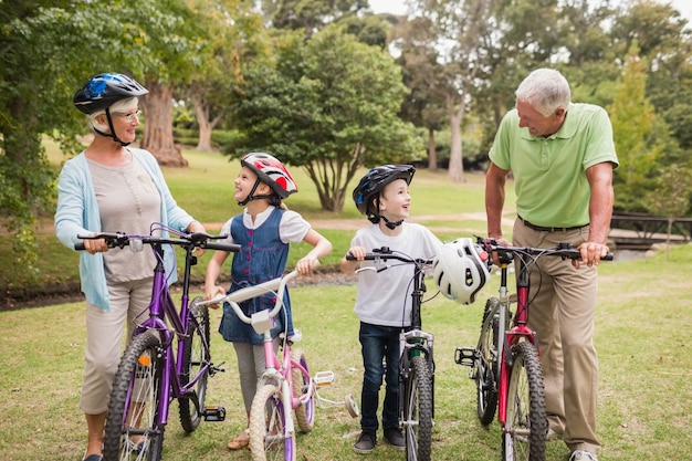 Happy grandparents with their grandchildren on their bike