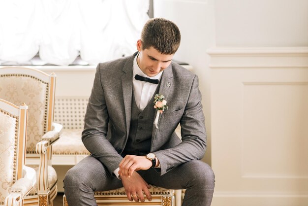 Happy groom Portrait of a young man Groom getting ready in the room for wed day