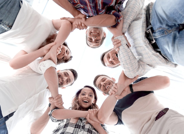 Happy group of businesspeople stacking their hands in cooperation