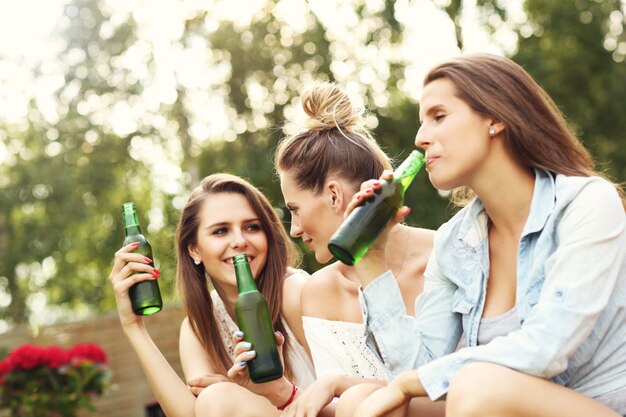 happy group of friends having a beer outdoors