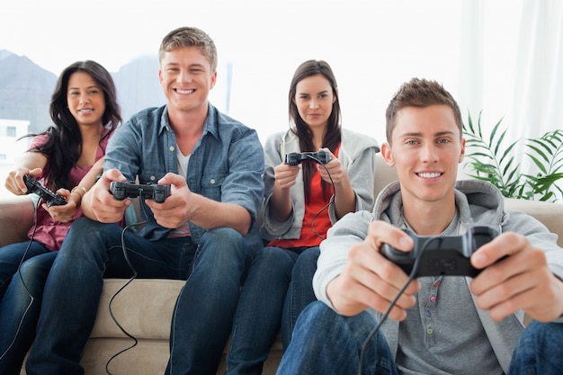 A happy group of friends playing games together while looking at the camera