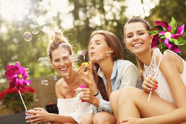 happy group of friends sitting outdoors