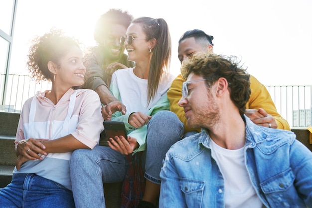 Happy Group of friends sitting together on a sunny day