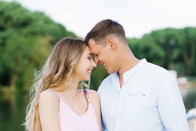 Happy guy and girl smiling outdoors in the Park