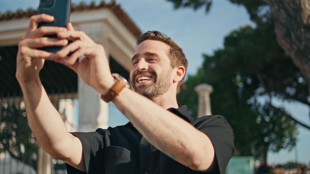 Happy guy talking phone camera on city street close up cheerful man video call